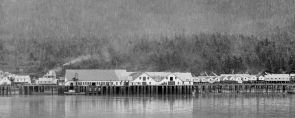 Claxton Cannery buildings in the distance viewed from the water.