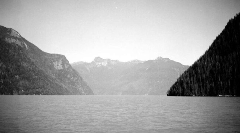 Head of Kingcome Inlet with steep sided mountains lining each side.