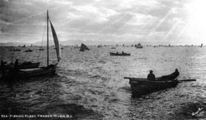 Several small fishing boats on the Fraser River. Text at the bottom of the image says: "926- Fishing fleet, Fraser River, B.C."