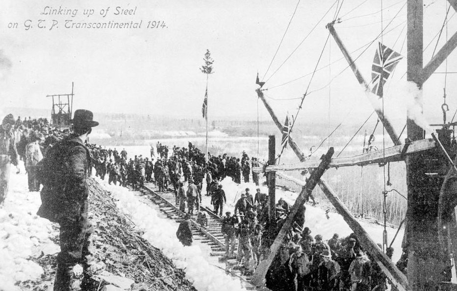 A celebration at Fort Fraser for the linking of the steel on the Grand Pacific Railway. Text on the image reads: "Linking up of steel on G.T.P. Transcontinental 1914."