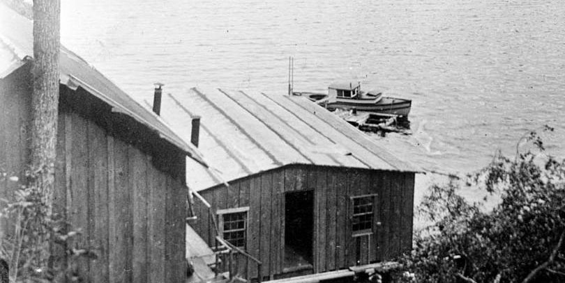 Deux cabanes en bois au bord de l'eau.