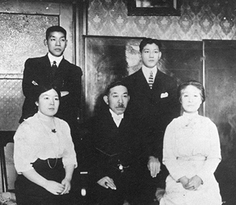 Posed family portrait of Manzo Nagano with his wife and family.