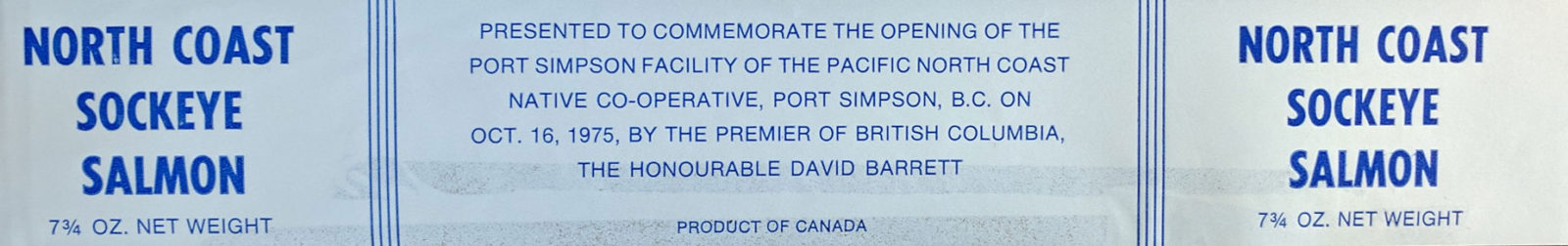 Monochrome blue label features only text, no images. "North Coast Sockeye Salmon. Presented to commemorate the opening of the Port Simpson facility of the Pacific North Coast Native Co-operative, Port Simpson, BC, on Oct 18th 1975 by the Premiere of British Columbia, the Honourable Dave Barrett.