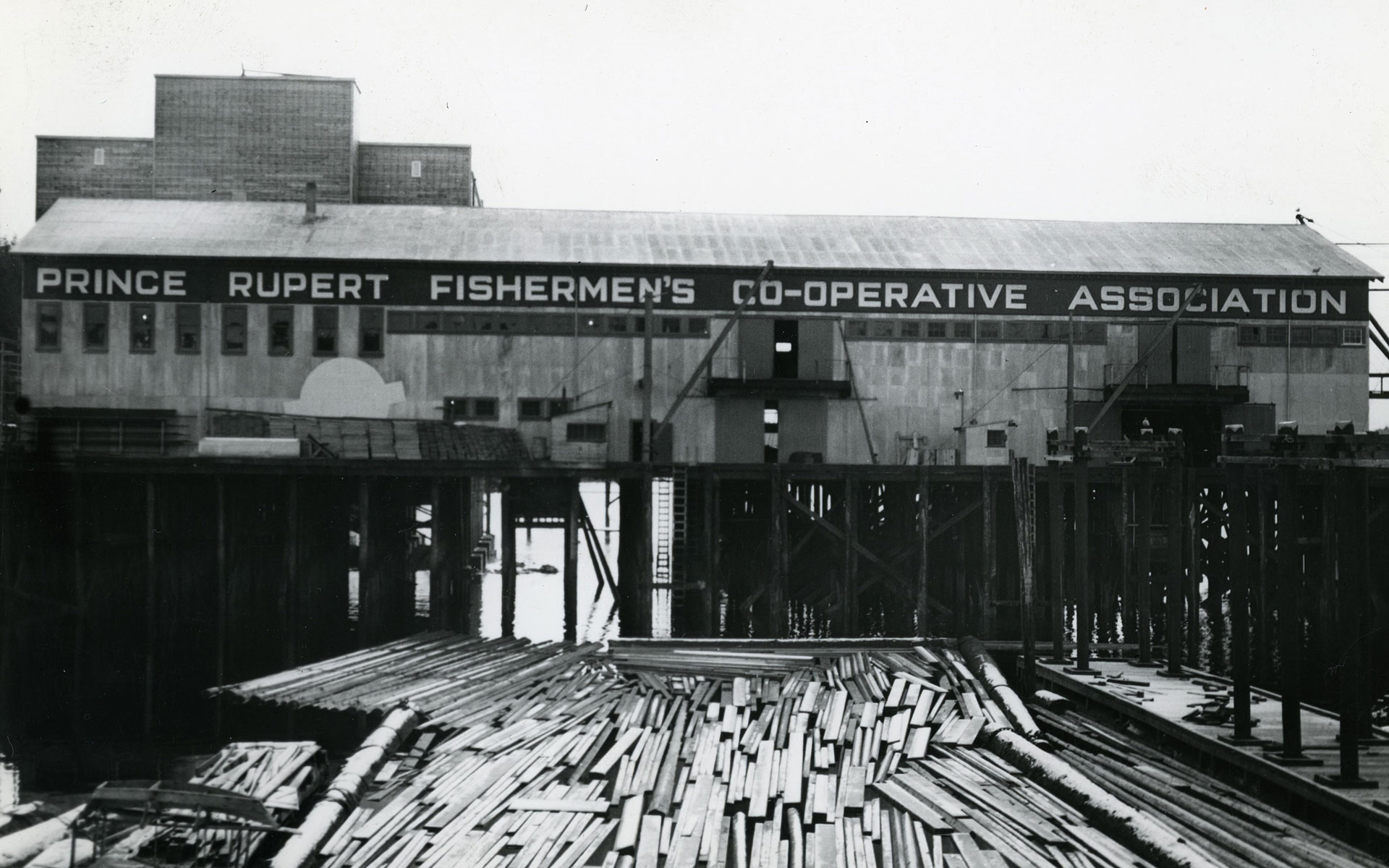 Exterior view of fish shed on pilings.
