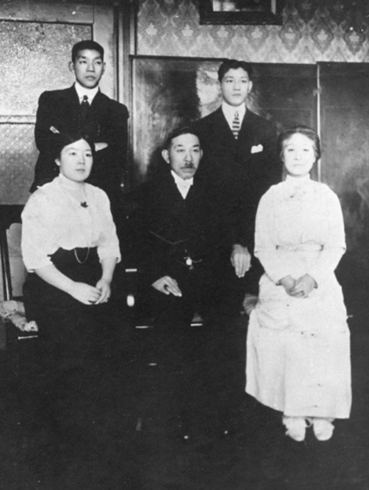 Posed family portrait of Manzo Nagano with his wife and family.