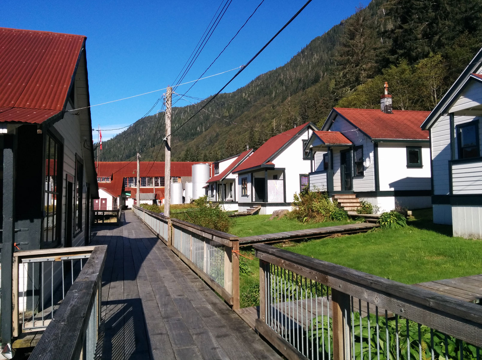 Boardwalk and row of small cannery housing buildings.